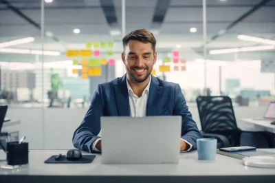 opti man behind desk with laptop SH