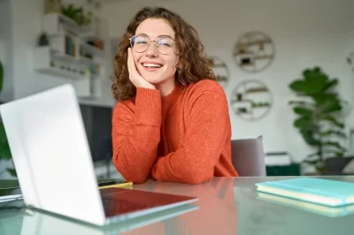 opti relaxed woman with laptop behind desk